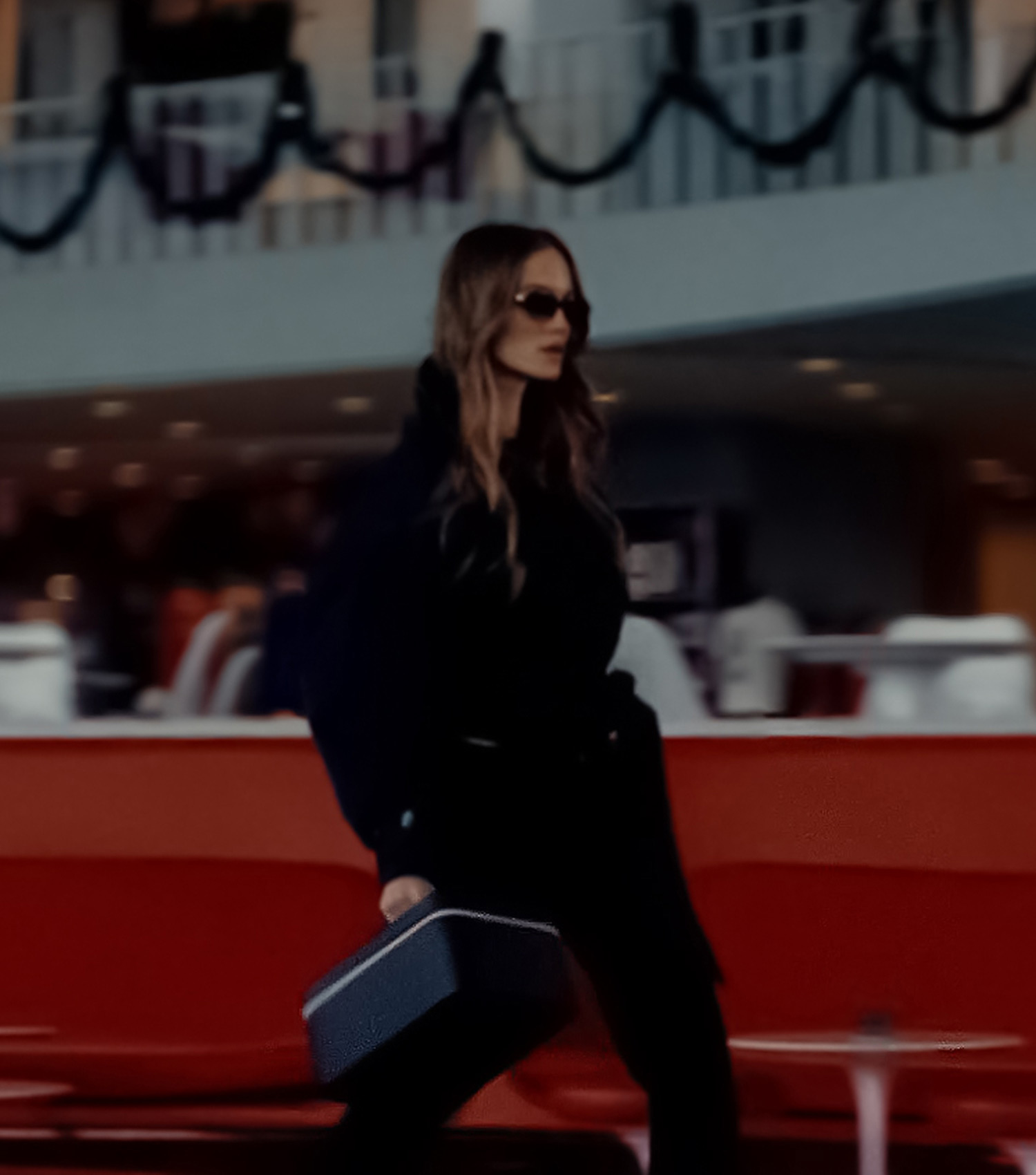 Woman walking through airport with CAIA advent calendar